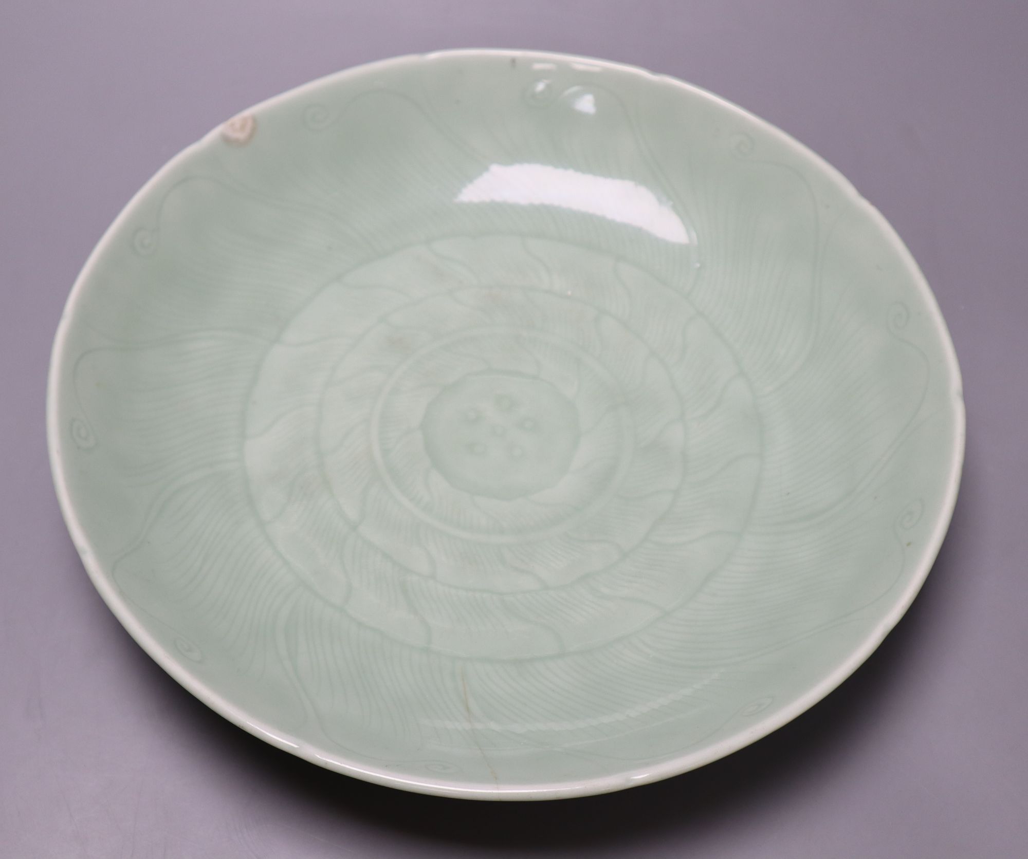 A 19th century Chinese celadon lotus dish, diameter 33cm (faults)